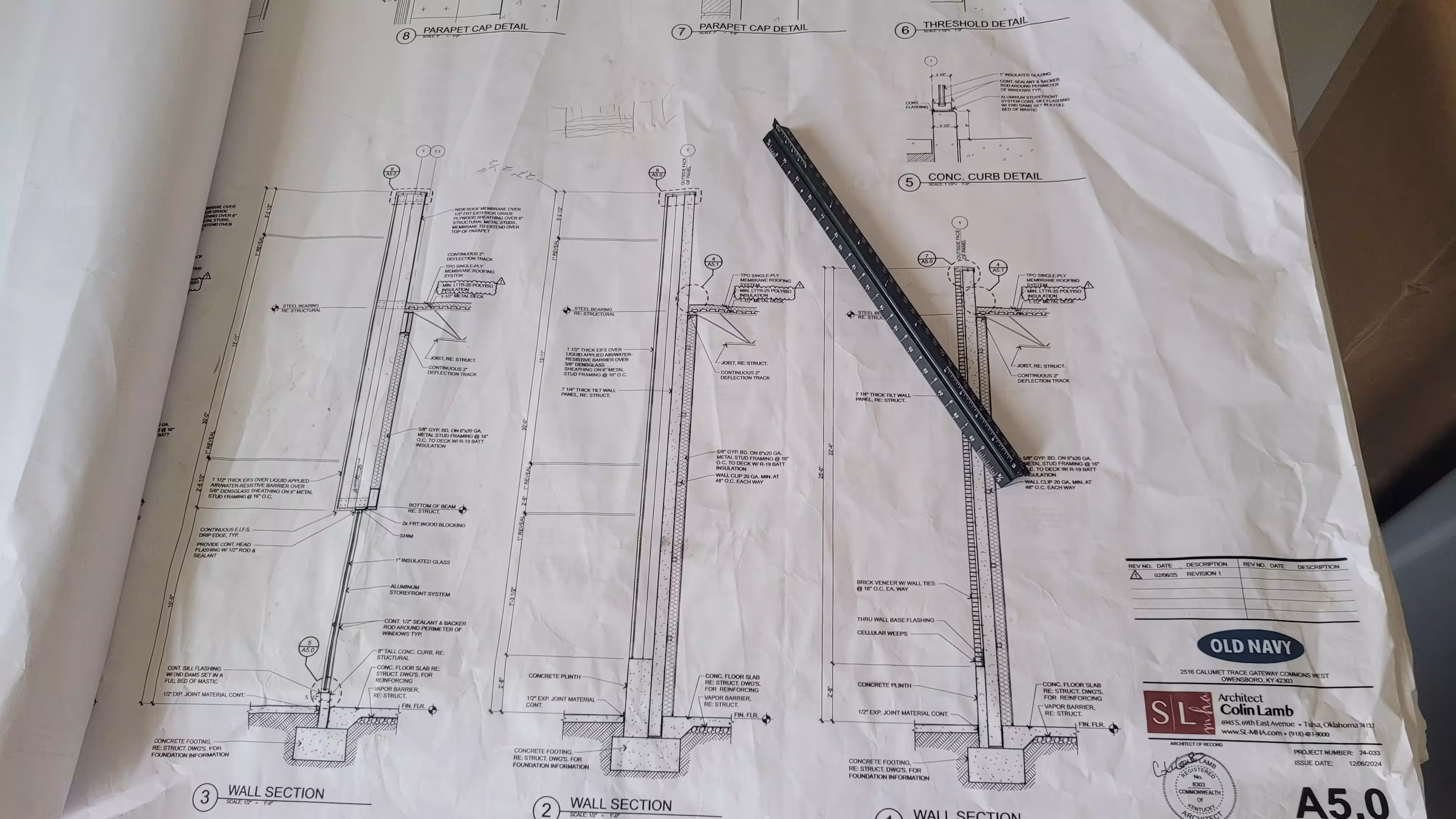 Blueprints and digital tablet with construction plans.