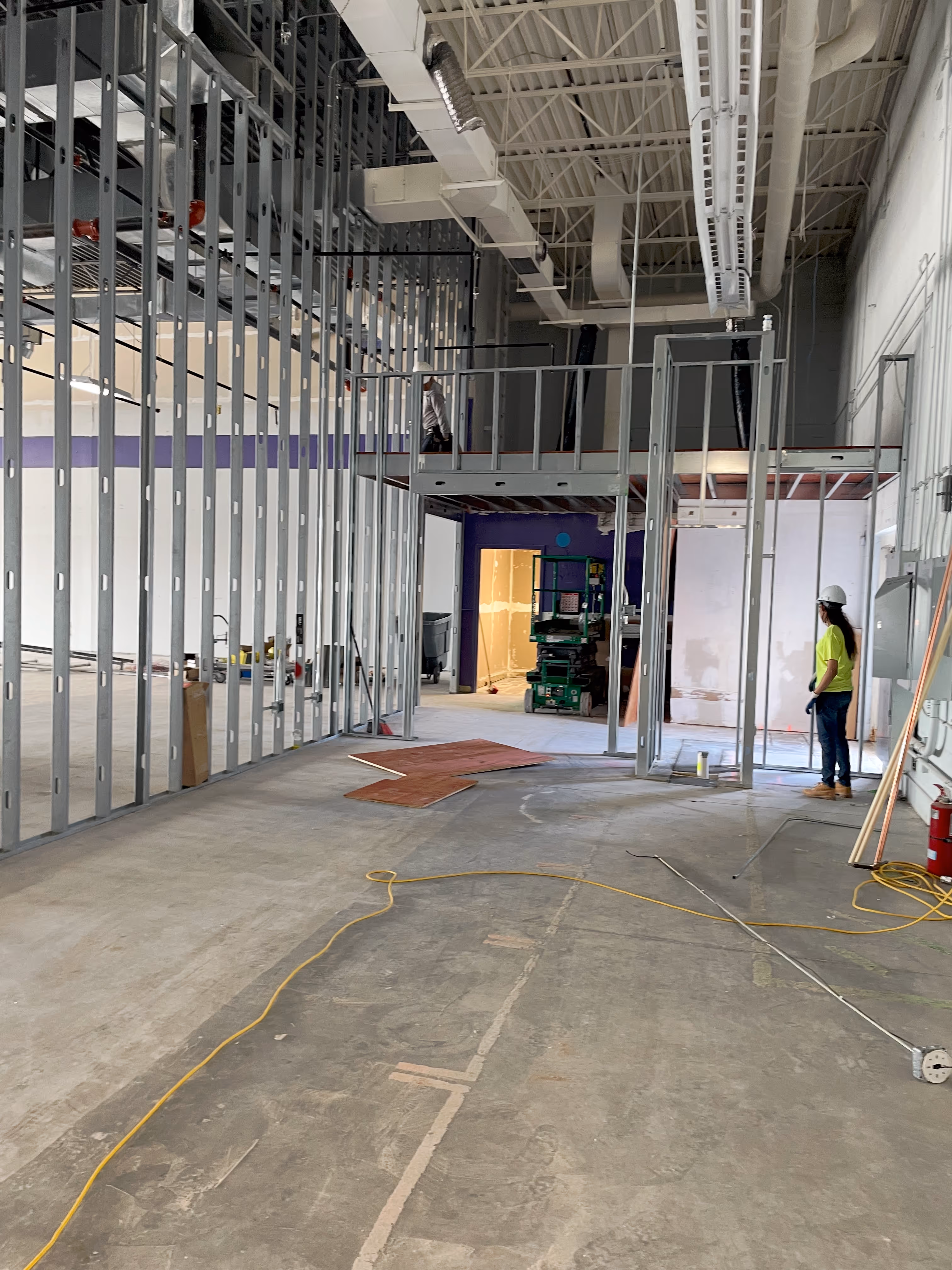 Construction team installing framing and drywall in a modern building
